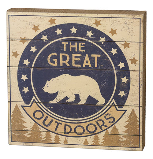 This small wooden box sign depicts a navy blue circle with a bear&