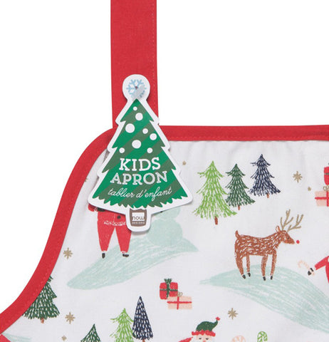 This close-up shot is of a corner of the Christmas apron with a green Christmas tree shaped tag attached to it.