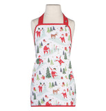 This white apron outlined in red has a design of Santa Claus and reindeer in different poses, including reaching the top of a Christmas tree.