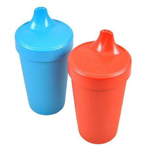 There are two sippy cups one red and one blue.