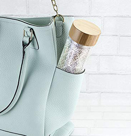 The glass with the tea infuser is shown sticking out of a purse pocket.