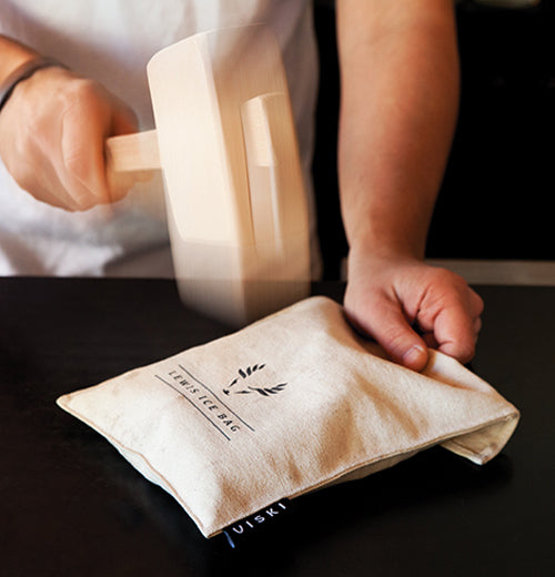 The mallet is shown pounding the Lewis Ice Bag.