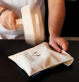 The mallet is shown pounding the Lewis Ice Bag.