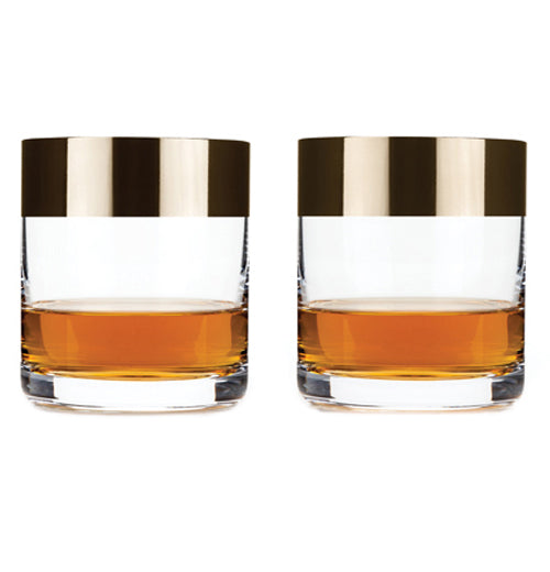 Some liquor is shown inside both the bronze rimmed glasses.