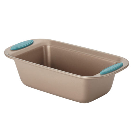 The "Blue" Loaf Pan is a bronze pan with blue handles it is shown from a semi front view.