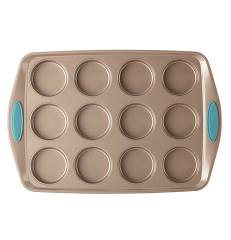 The 12 Cup "Blue" Muffin Pan is on display on a white background. The pan is a bronze color that has 12 cup holes with blue handles. 