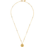 A brass necklace with a pendant. The pendant has a star design and a turquoise stone in the middle.