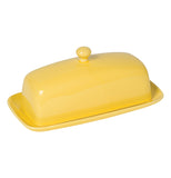Lemon yellow ceramic two piece butter dish with a round knob on top of the cover.