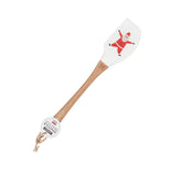 The white rubber spatula with the Santa Claus picture is shown with its tag attached to the end of its wooden handle.