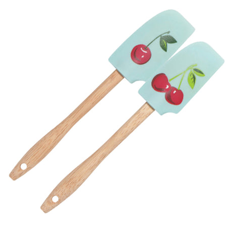 These two turquoise rubber spatulas both feature a design of red cherries covering them. One shows a single red cherry while the other shows two cherries connected to each other.