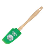 This rubber spatula has a wooden handle and green head with a picture of a sheep wearing a green and red hat. Below the sheep are the words, "Baaa Humbug" in white lettering.