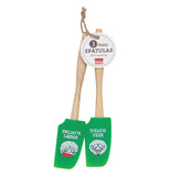 The two green rubber spatulas with the sheep pictures are shown attached to each other with their tag attached to the ends of the wooden handles.