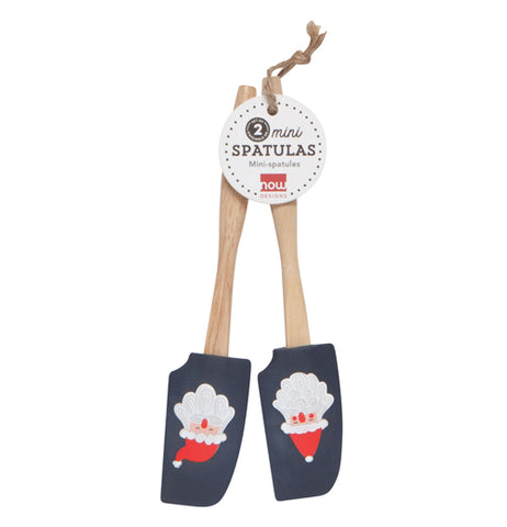 The two rubber spatulas with two Santa Claus head pictures on their black rubber heads are shown tied together with their tag attached between them.