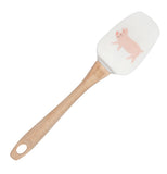 A spatula with a wooden handle and a white head with the picture of a pig on it.