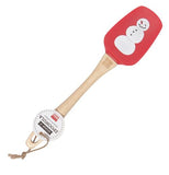 The red rubber spatula with the snowman picture is shown with its tag attached to its wooden handle.