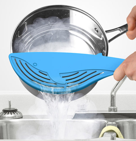 Big blue whale strainer being used to stain water out of a pot.
