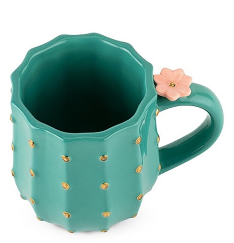 The cactus-shaped mug with the flower is shown from above, looking down on it.
