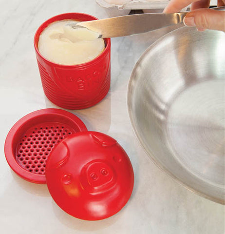 This picture has the bacon bin in three pieces the bin filled with grease the strainer and the lid.