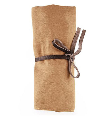 The pouch containing the tools is shown wrapped and tied closed.