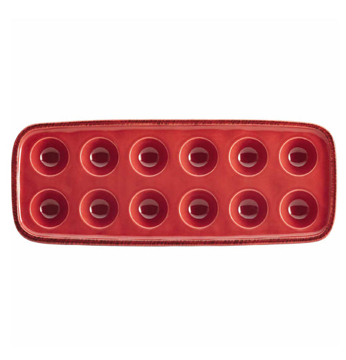 The top of a red tray capable of holding twelve eggs is shown.