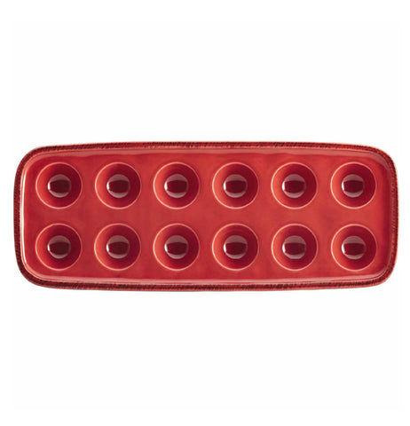 The top of a red tray capable of holding twelve eggs is shown.