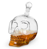 The glass container shaped like a human skull is shown with an alcoholic beverage in it.