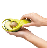 Person removing an avocado pit with the Avocado Tool.