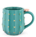 This green mug has golden yellow spots all around it and a pink flower on its handle to make it look like a saguaro cactus.