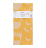 "Crecsendo" jacquard yellow tea towel with white shape design folded up with a white wrapper band on it.