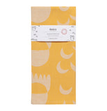"Crecsendo" jacquard yellow tea towel with white shape design folded up with a white wrapper band on it.
