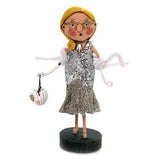 The Scarlette Starlet figurine is dressed up in sequin and a white scarf while holding a white trick or treat bucket.