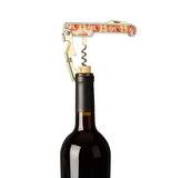 The corkscrew with the poppy design is shown pulling out a cork from a wine bottle.