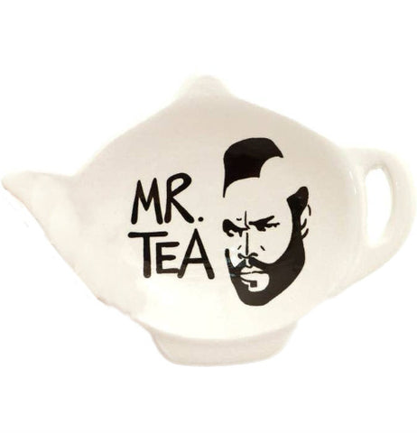 A small white stoneware dish in the shape of a tea pot. In black, it reads "Mr. Tea." with an outline of Mr. Ts' head.