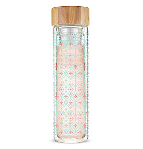 This thin glass mug with a wooden lid has a design of red cross shapes surrounded by turquoise criss-cross patterns.