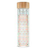 This thin glass mug with a wooden lid has a design of red cross shapes surrounded by turquoise criss-cross patterns.