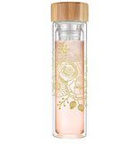 This glass bottle with a wooden lid has a pink metal infuser and features a gold rose stencil design.