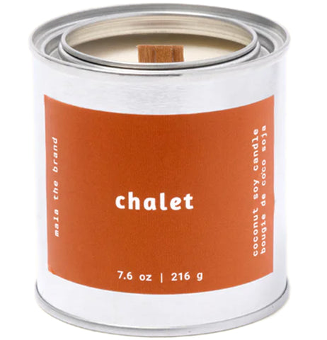 A gray tin candle-shaped can with a red label. The label says "Mala the brand--chalet--Net weight 7.6 oz. -- coconut soy candle."