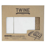The cutting board with the wire cutter is shown inside its cardboard packaging. The word, "Twine" is shown at the top of the box in black lettering.