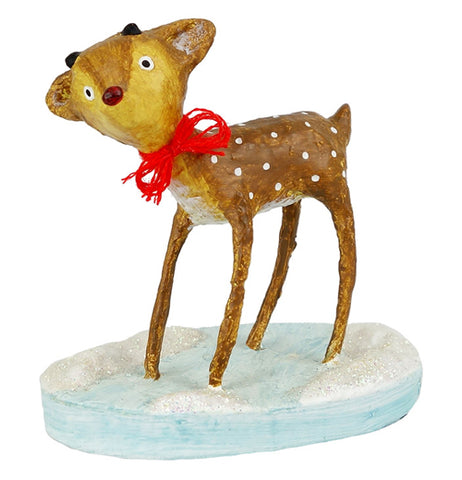 This brown and white speckled reindeer is shown wearing a red bow around its neck, while standing on a round icy blue base.