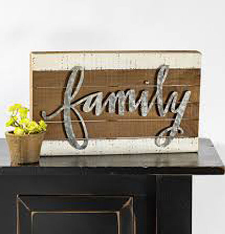 The wooden box with yellow flowers sitting next to it on top of a black table.