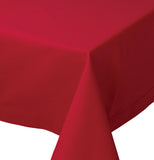 Close up of a table's corner that is covered with the red "chili" hemstitched tablecloth.