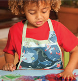 A child in a red shirt is shown wearing the ocean apron.