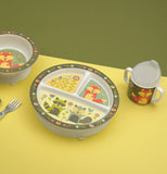 The sipping cup with the fox against the green flower background is shown sitting next to a plate and bowl, both of which have a similar design.