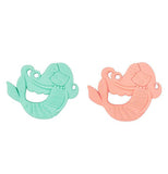 This image shows two different colored silicone teething objects shaped like mermaids with long hair and tails. The one on the left is teal green, and the one on the right is salmon pink.