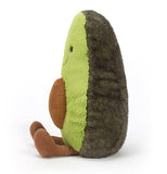 The side view of a brown and green stuffed medium "Amuseable Avocado" with feet sticking out and brown pit in its tummy.