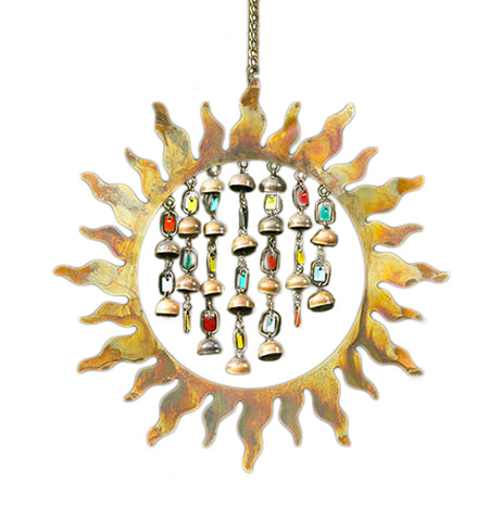 This Sun Shaped Wind Chime has Bronze Colored Bell Shaped chimes and Multicolored Tags Hanging Down in the middle of it.