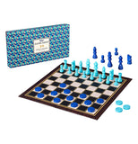 This black and white board sports light blue chess pieces and dark blue checkers pieces. Its blue box sits behind it with a white sign on it. On the white sign are the words, "Ridley's Games Room Chess and Checkers" in black lettering.