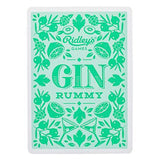 The back of One of the "Gin Rummy" Playing Cards shows green lemons, olives, martini glasses and other cocktail ingredients on a light green background. 
