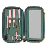 Green colored eyebrow kit laying open displaying five eyebrow tools used to groom the eyebrows.