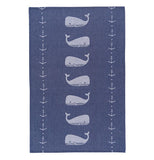 The blue dishtowel has white whales and white anchors running down the towel.